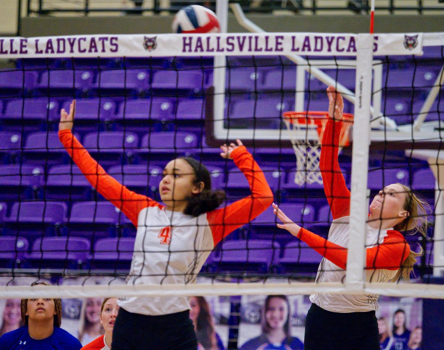 Jayla Jackson acts as decoy as Mylee Fischer hits it from mid-court. [view more volleyball shots]